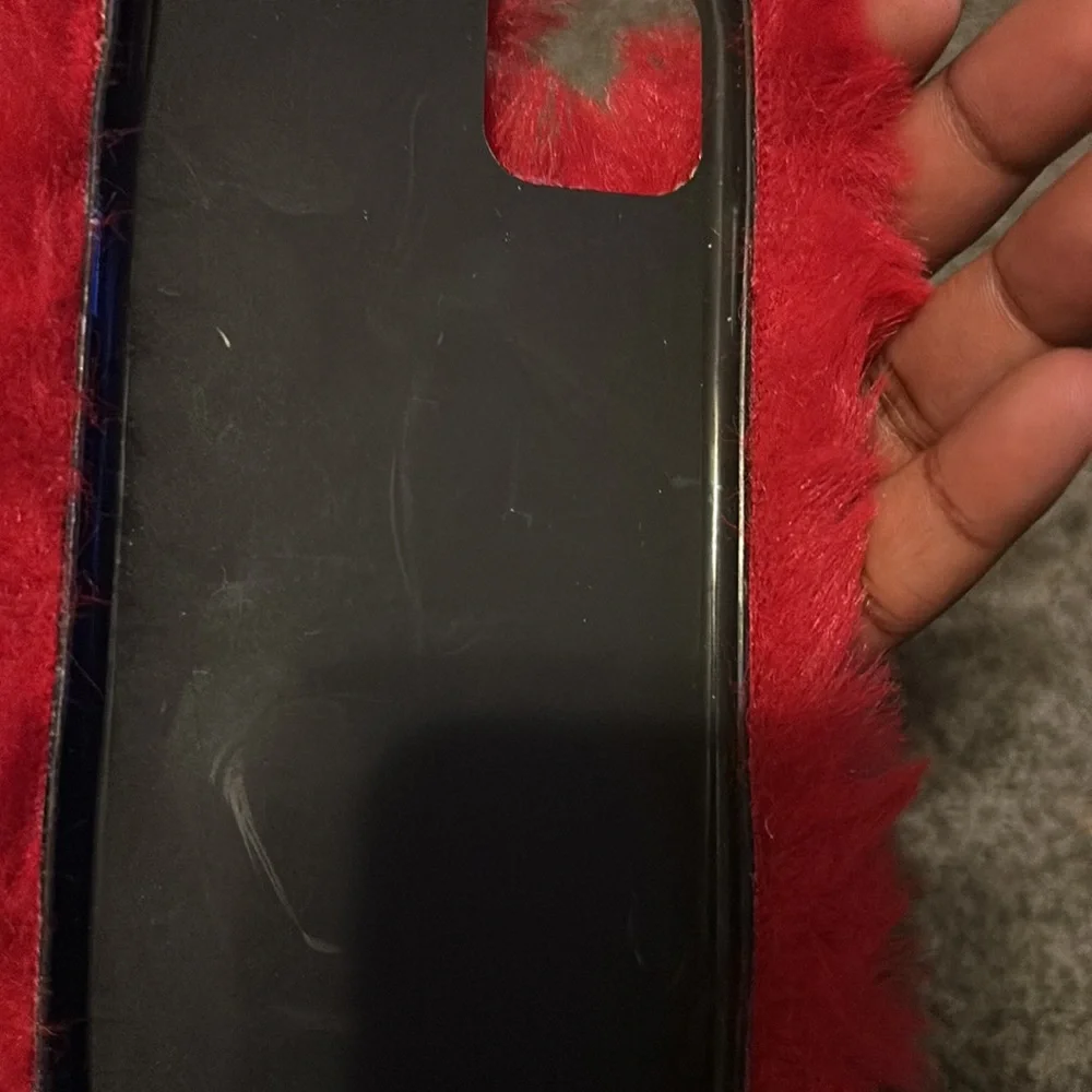 This is a fuzzy red case for a iPhone 11 pro max. There is a few little scratch. - Picture 3 of 4